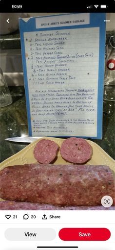 two sausages sitting on top of a yellow plate next to a sign that says,