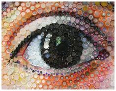 an eye made out of many different colored circles and bottles in the shape of buttons