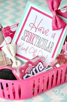 a pink basket filled with lots of different items next to a sign that says have a spinitaculaular kind of love