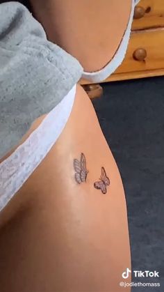 two butterflies on the side of a woman's stomach