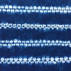 blue and white tie - dyed fabric with vertical lines in the center, as well as horizontal stripes