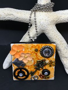 a close up of a small purse on a black surface with a chain attached to it