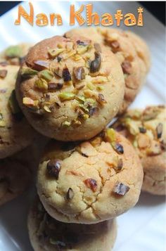 there are many cookies that have nuts on top of each one and the words nann khatataa above them