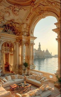 an ornate living room with large windows overlooking the water