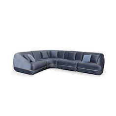 a large blue sectional sofa with pillows on the top and bottom corner, in front of a white background