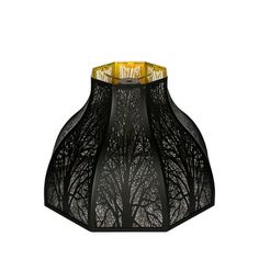 a lamp that is on top of a white surface with trees in the background and gold trimmings