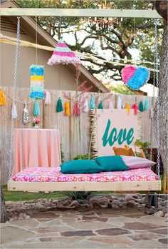 an image of a swing bed in the backyard with decorations on it and a sign that says love