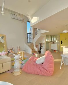 a living room filled with lots of furniture and decor on top of hard wood flooring