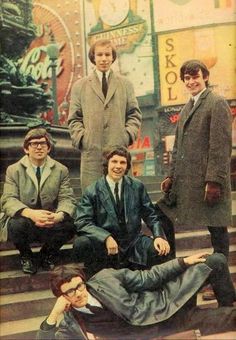 an old photo of men sitting on the steps