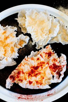 three pieces of pizza sitting on top of a white plate covered in melted cheese and sauce