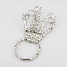 Are you looking for a bracelet to spice up your outfit, one that will give you a gothic and fantastic look at the same time? Then look no further because this Women's Skeleton Hand Bracelet will enable all of that. It wraps around your wrist and allows each of your fingers to be impressively decorated with stunning rings. The Women's Skeleton Hand Bracelet is made of carefully chosen materials - top-quality alloy, resistant to rust, oxidation, and discoloration, making it an ideal long-lasting a Lenore Cosplay, Skeleton Hand Bracelet, Skeleton Fashion, Hand Skull, Hand Skeleton, Skeleton Bracelet, Skeleton Jewelry, Women Skeleton, Elastic Rings