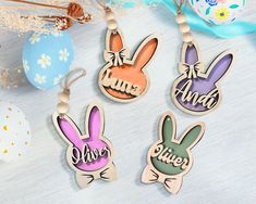 three wooden keychains with the words easter and two bunny ears hanging from them