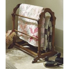 a baby crib with quilts and shoes on the floor