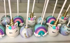 there are many unicorn cake pops on the table