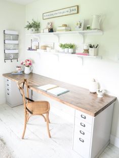 a wooden desk sitting in the middle of a room next to a chair and bookshelf