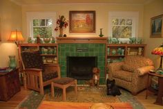 a living room filled with furniture and a dog sitting in front of a fire place