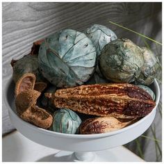 a white bowl filled with different types of fruit