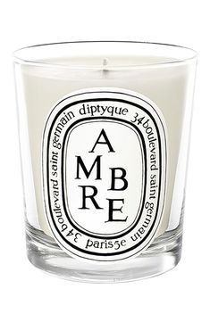 a glass candle with the words ba e s printed on it's front and side