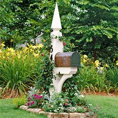 a mailbox in the middle of a garden