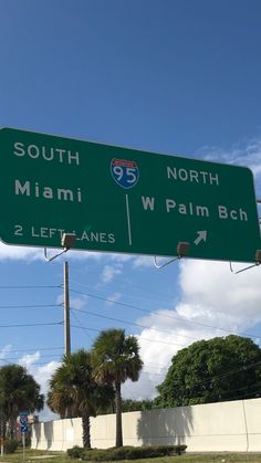 a green street sign that says south miami and west palm beach on it's side