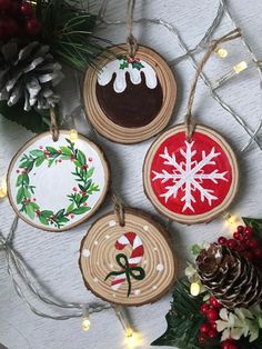 christmas ornaments are hanging from string on the table