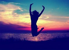 a woman jumping in the air with her arms up and text that reads, freedom