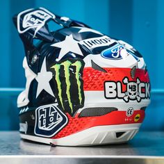 a motorcycle helmet with an american flag design on the front and side, sitting on top of a table