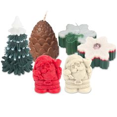 christmas candles are lined up in different shapes and sizes, including one with a santa clause on it