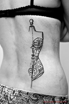 a woman's stomach with a tattoo on it