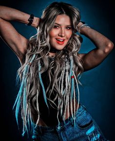 a beautiful woman with long hair and fringes on her head posing for the camera