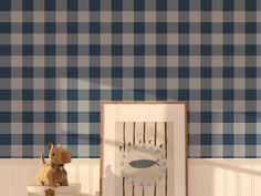 a small dog is standing next to a blue and white checkered wallpapered room