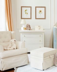 a baby's room with white furniture and sunflowers on the wall