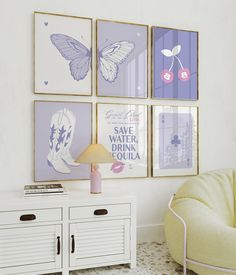 a living room filled with furniture and pictures on the wall next to a white cabinet