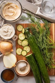 The ingredients for creamy cucumber salad sit on a table. There are cucumbers, dill, onions, mayo, sour cream and salad and pepper. Cucumber Salad With Mayo, The Perfect Salad, Perfect Salad, Creamy Cucumber Salad, Creamy Cucumbers, Famous Recipe, Summer Gathering, Fresh Dill, Cucumber Salad