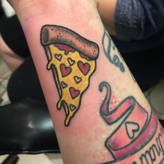 a piece of pizza with hearts on it and the word love is spelled in cursive writing