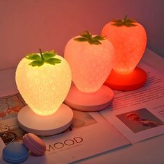 two strawberry shaped lights sitting on top of a table