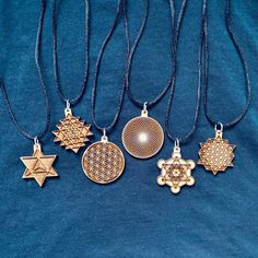 five different necklaces are shown on a blue background, one is gold and the other is silver