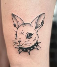 a small rabbit tattoo on the thigh