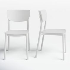 two white chairs sitting next to each other