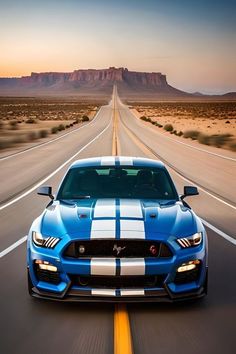 a blue and white mustang driving down the road