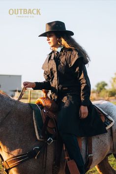 a woman riding on the back of a brown horse