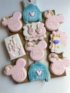 decorated cookies are arranged in the shape of mickey and minnie mouses ears with names on them