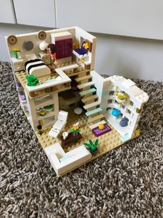 a toy house made out of legos on the floor