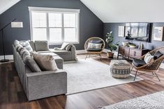 a living room filled with furniture next to a window and hard wood floored floors