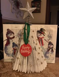 a christmas tree made out of books and paper