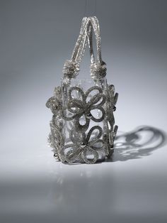 This chic Chrysanthemum Crystal Flower Bag In Silver is crafted from sparkling crystal and features an elegant shoulder strap. Perfect for a special occasion, this bag adds a touch of sophistication to any outfit.    Material: PVC   Crystal shoulder straps Chic Embellished Crystal Evening Bag, Luxury Evening Bag With Handles For Events, Formal Embellished Shoulder Bag, Chic Crystal Evening Bag For Events, Luxury Silver Shoulder Bag With Pearl Handle, Luxury Silver Bag With Pearl Handle, Glamorous Silver Bag With Detachable Handle, Elegant Double Handle Bag With Pearl Detail, Elegant Double Handle Bag With Pearl Handle