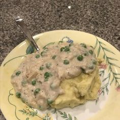 a plate topped with mashed potatoes covered in gravy