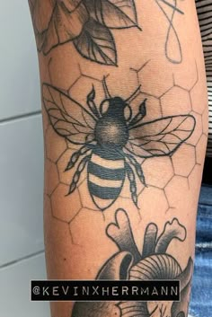 a bee and honeycomb tattoo on the arm