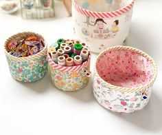 three baskets filled with different types of sewing thread