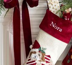 a christmas stocking hanging from the side of a fireplace next to other holiday decorations